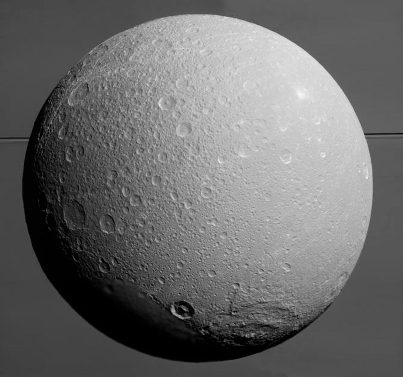A close-up image of Saturn's moon Dione, as taken by NASA's Cassini spacecraft.