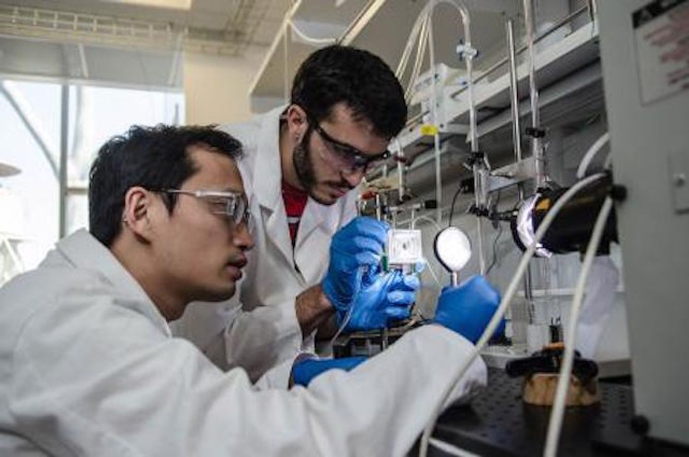 Chengxiang Xiang and Erik Verlage, JCAP team members, assemble part of the artificial leaf.