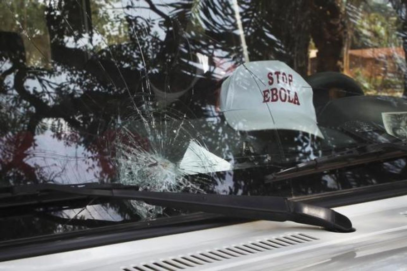 The broken windshield of an Ebola emergency team vehicle is seen after it had been pelted with stones in Lola February 9, 2015.