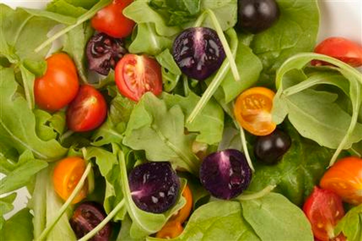 This image provided by The John Innes Centre, UK, shows a salad made with red and purple tomatoes. A small British company is planning to apply for U.S. permission to produce and sell purple tomatoes that have high levels of anthocyanins, compounds found in blueberries that some studies show lower the risk of cardiovascular disease and cancer. The Food and Drug Administration would have to approve any health claims used to sell the products. Cancer-fighting pink pineapples, heart-healthy purple tomatoes and less fatty vegetable oils may someday be on grocery shelves alongside more traditional products.