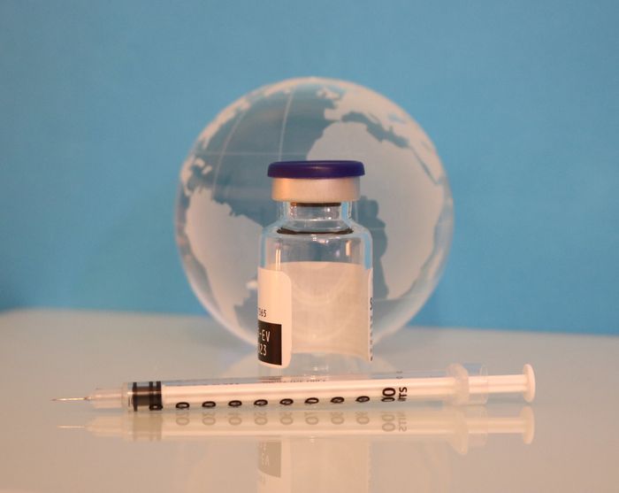A syringe, vaccine bottle, and glass globe. / Credit: NIAID 