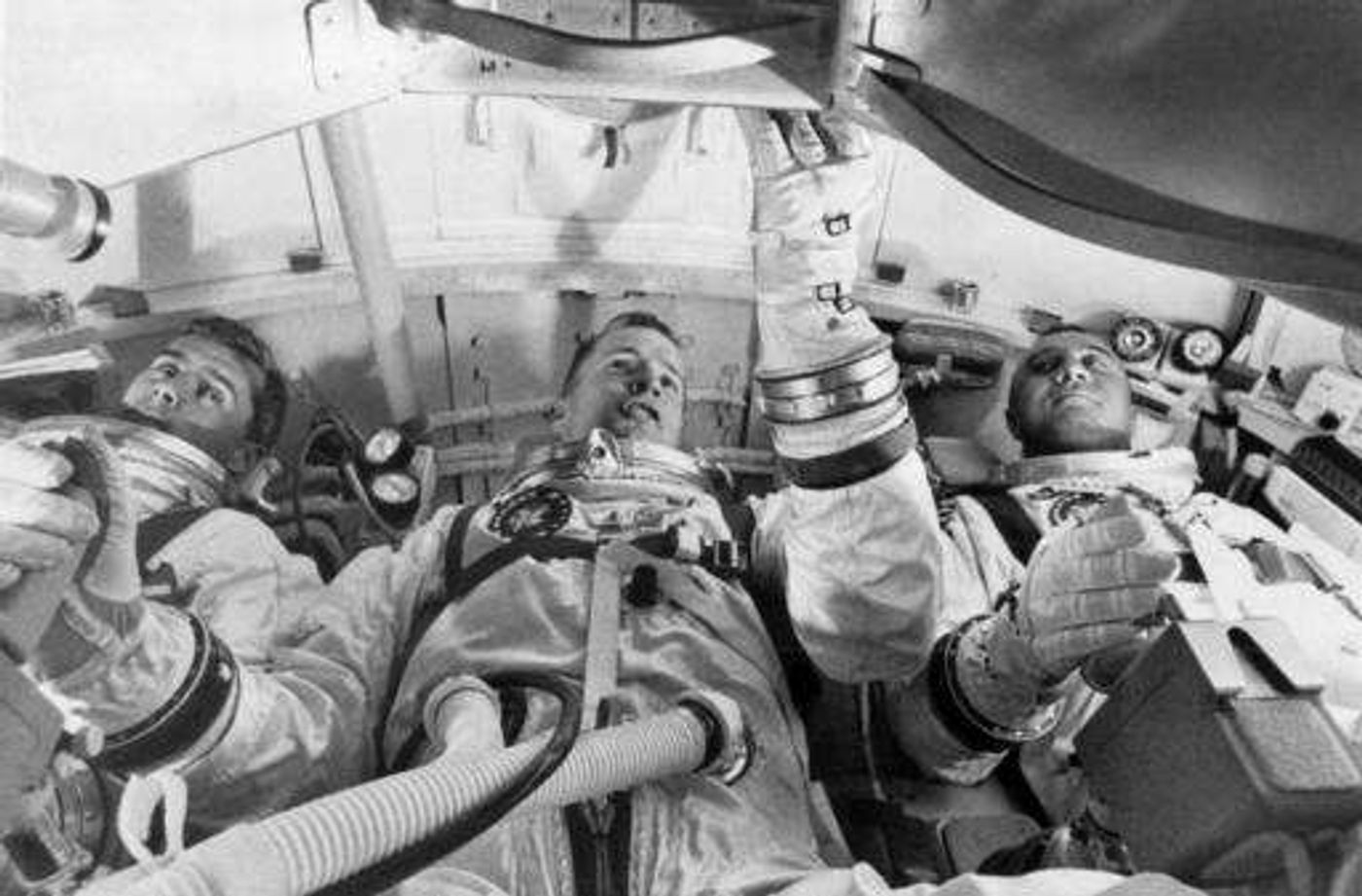 NASA astronauts from left, astronauts Roger Chaffee, Edward White II, and Virgil Grissom, practice for launch inside the Apollo 1 capsule.