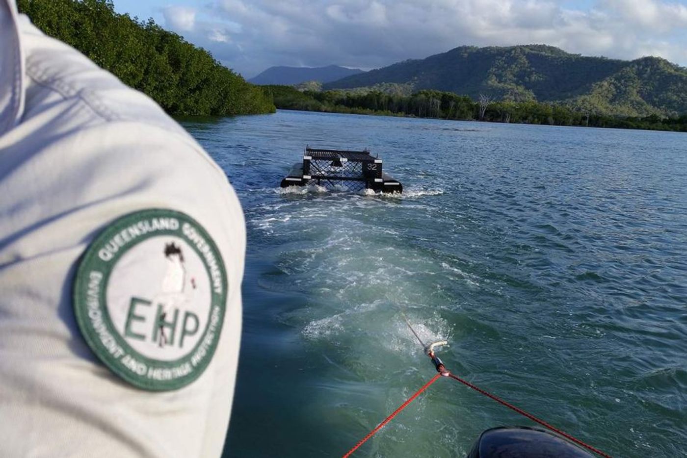 Department of Environment and Heritage Protection authorities reel in the giant crocodile.