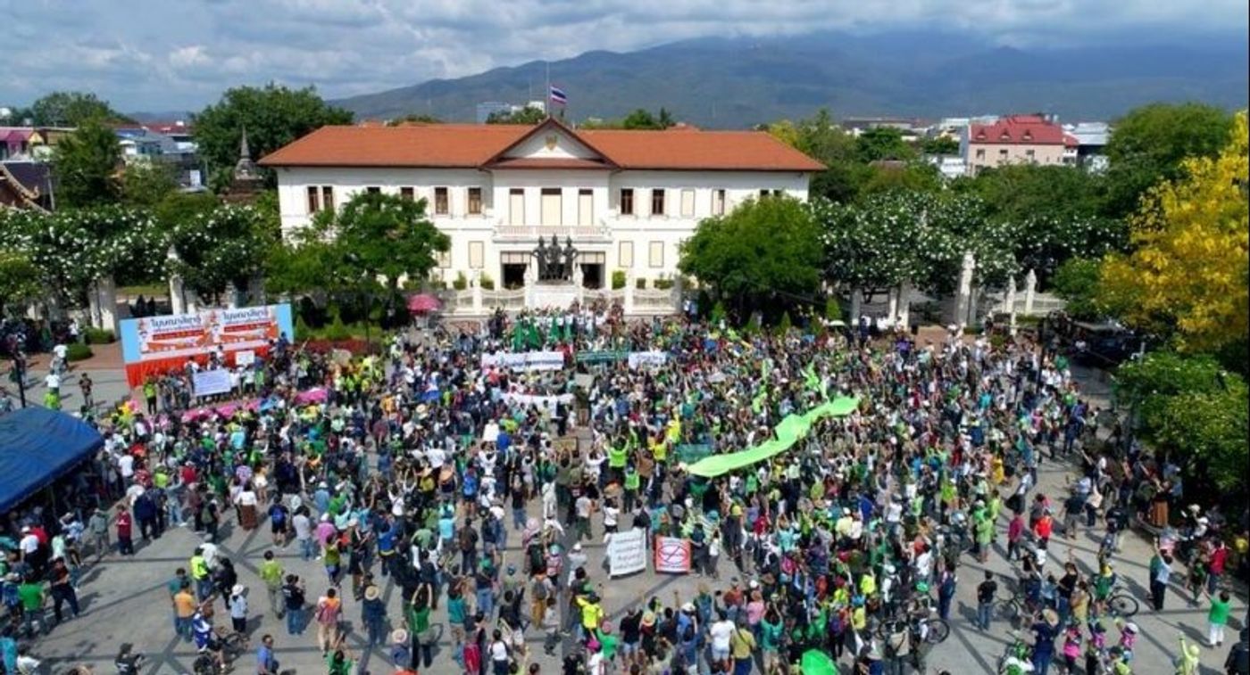 Many gathered to protest the housing development, showing their support with green ribbons. Photo: The Nation