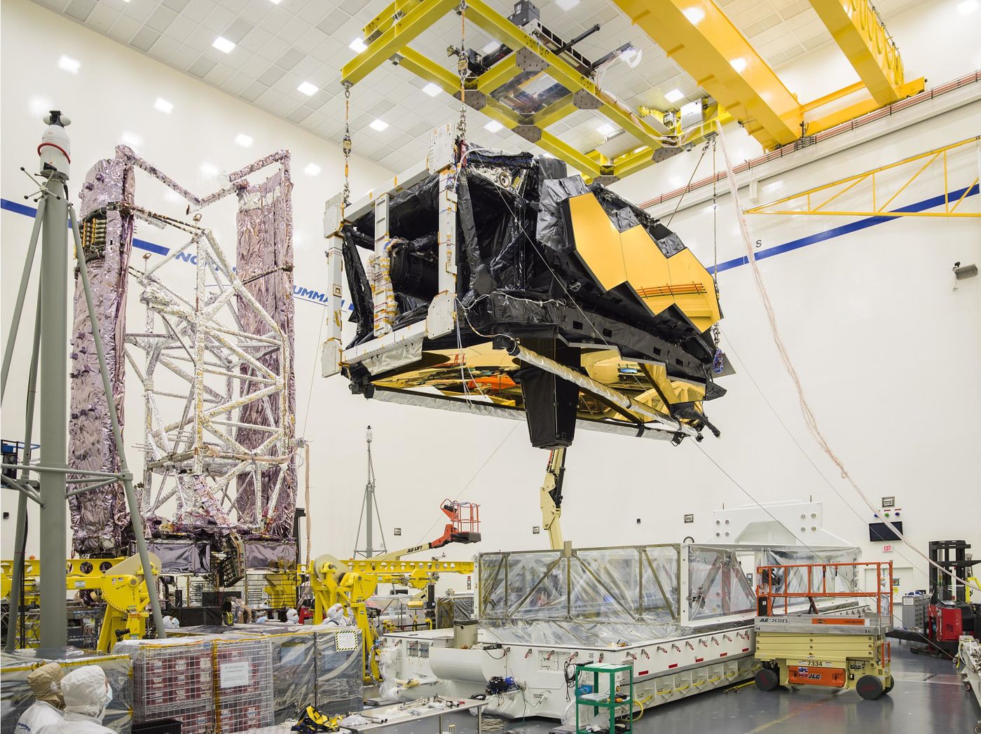 Engineers hoist the heart of the James Webb Space Telescope out of its shipping container at its final testing facility in California.