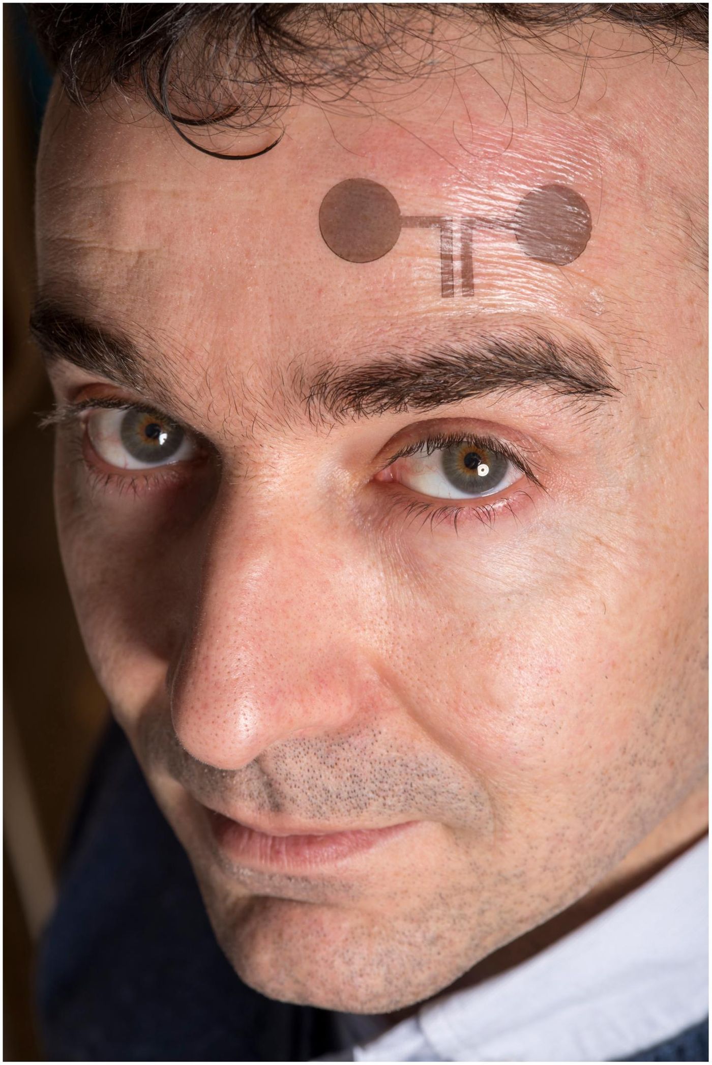 Francesco Greco with a temporary tattoo electrode. Credit: Lunghammer - TU Graz