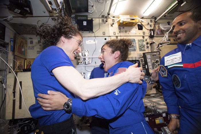 Christina Koch and Jessica Meir greet one another on the ISS.