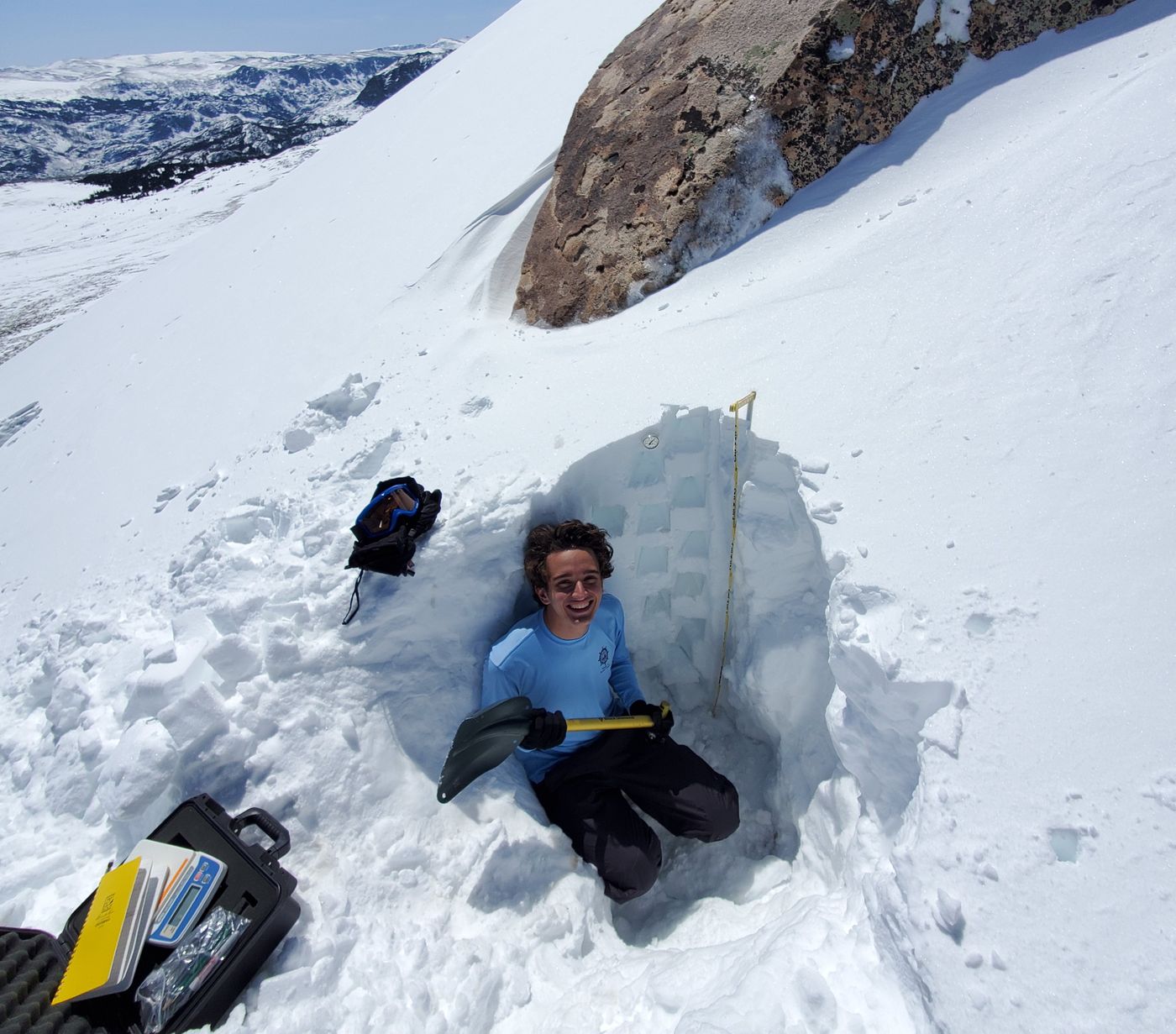 Digging a snow pit in the Wind River Range, Wyoming. (Credit: Elijah Boardman)