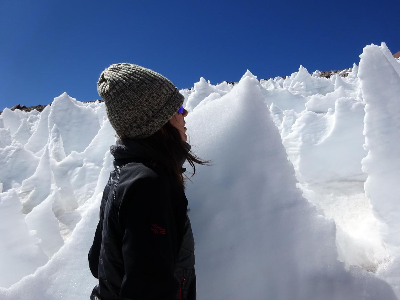 University of Colorado Boulder student Lara Vimercati examines a nieves penitente structure on Volcán Llullaillaco in Chile. / Credit: Steve Schmidt / University of Colorado Boulder