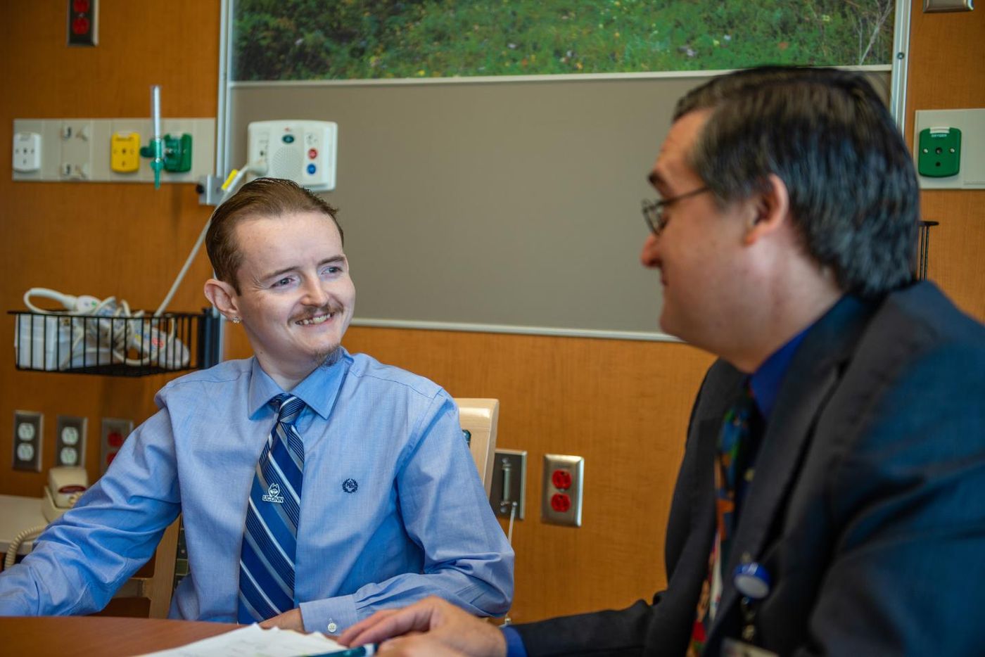 Jerrod Watts, a patient enrolled in the first clinical trial for Glycogen Storage Disease, chats with lead investigator Dr. David Weinsten. Photos taken in the dedicated Glycogen Storage Disease Unit at UConn Health. / Credit:Tina Encarnacion/UConn Health