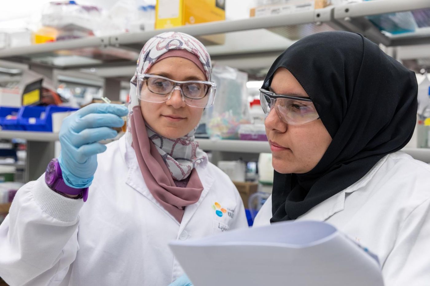 KAUST scientists develop AI that reveals genes driving tumor growth. Marwa Abdelhakim (left) and Sara Althubaiti are shown with some of the DNA library used in the study. / Credit: 2020 KAUST