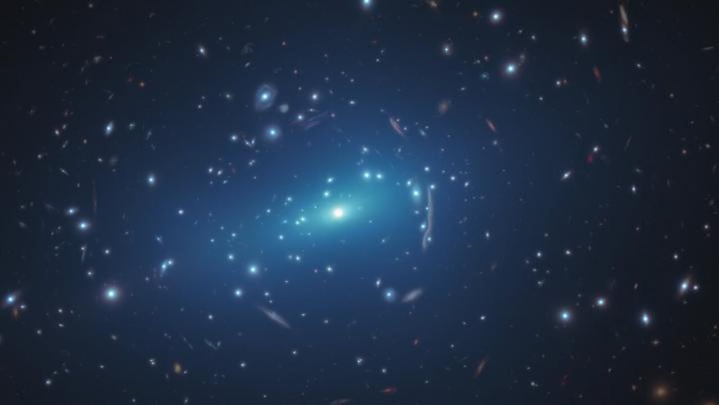 A NASA/ESA Hubble Space Telescope image of the massive galaxy cluster MACSJ 1206. Within the cluster are distorted images of distant background galaxies: arcs and smeared features caused by the dark matter in the cluster, whose gravity bends and magnifies the light from faraway galaxies, an effect called gravitational lensing. / Credit: NASA, ESA, G. Caminha, M. Meneghetti, P. Natarajan, the CLASH team, and M. Kornmesser