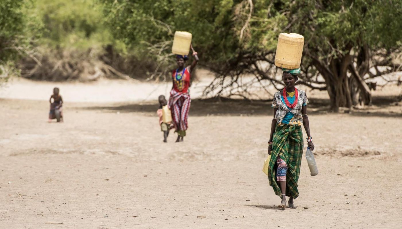 Turkana women carry water back to their dwelling, in northern Turkana. / Credit  Kennedy Saitoti, Mpala Research Centre