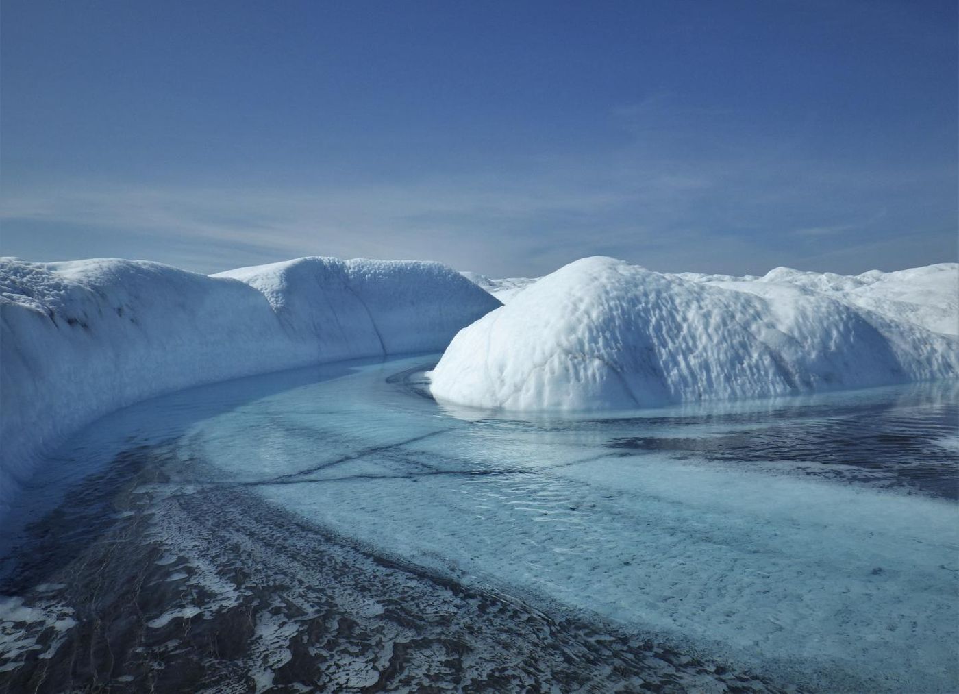 A supraglacial stream and sediment floodplain in southwest Greenland. / Credit: Sasha Leidman