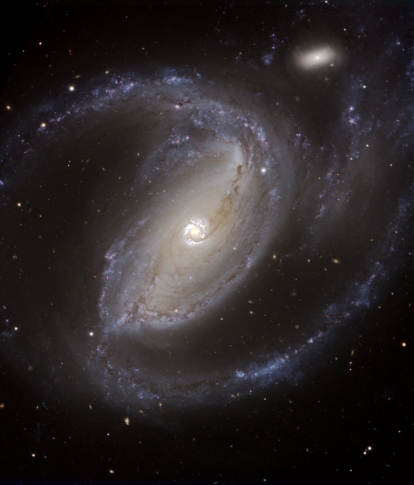 Spiral galaxy NGC 1097, a Seyfert galaxy like IZwicky1, the galaxy housing the supermassive black hole observed in the study.