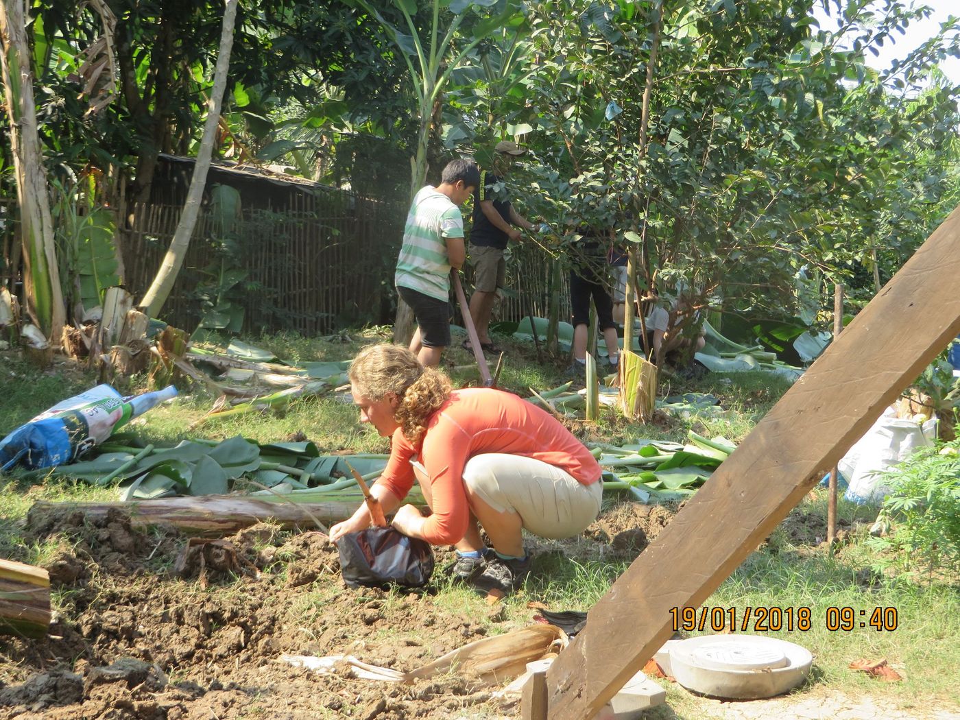 Transplanting banana tree stumps to higher ground to prevent flooding during monsoon season at a local farm near Banteay Chhmar, Cambodia. (Credit: Abbie Sandquist)