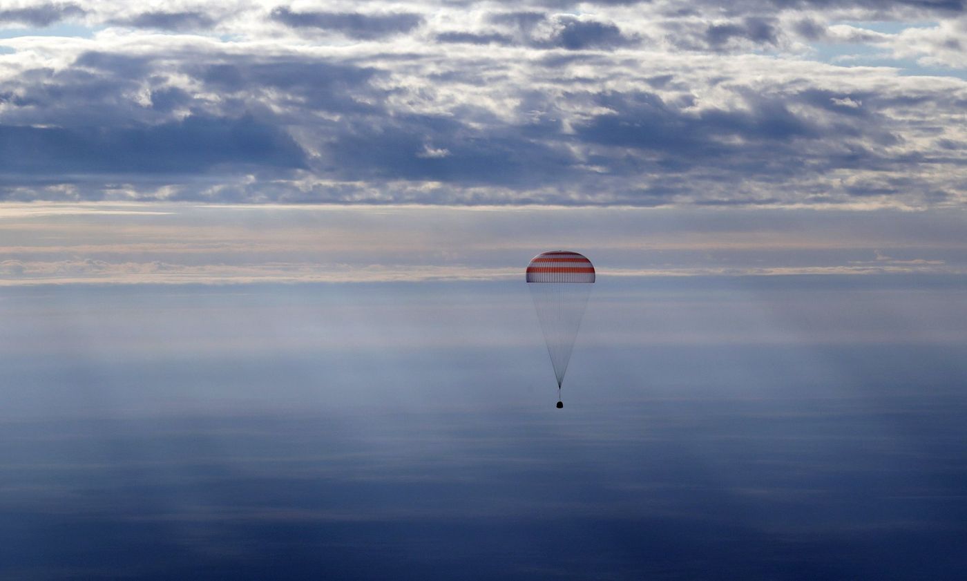 An upgraded Soyuz spacecraft carrying three ISS astronauts lands back on Earth safely.