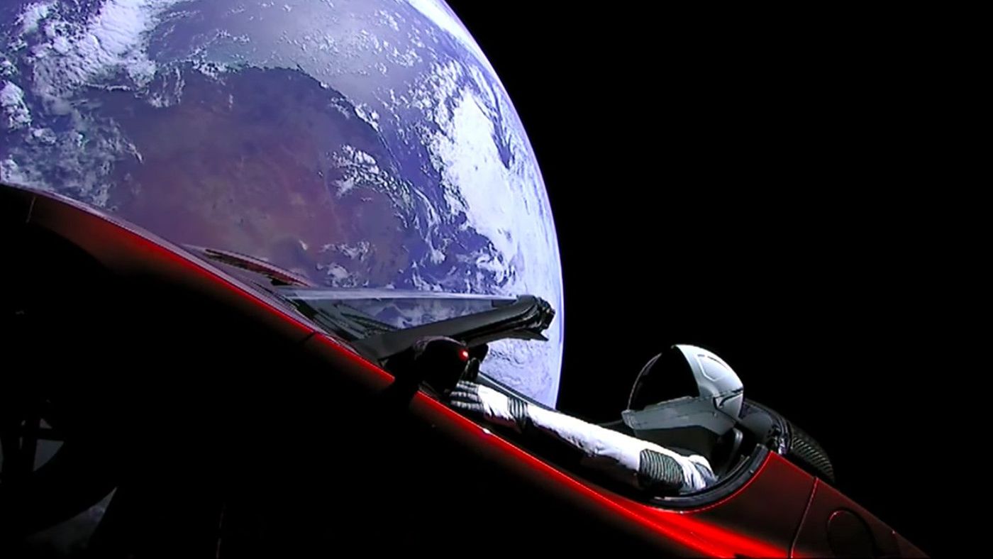 Elon Musk's cherry red Tesla Roadster floating in space as seen from cameras mounted on the car itself. 