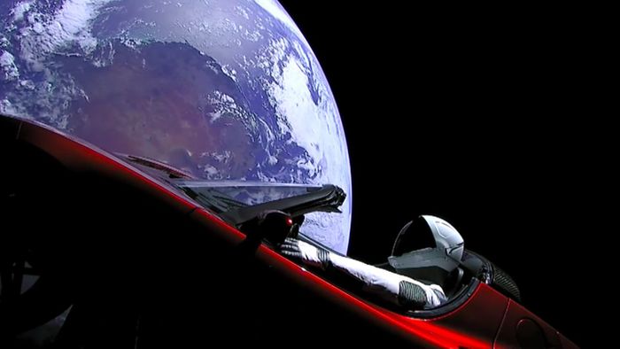 Elon Musk's cherry red Tesla Roadster floating in space as seen from cameras mounted on the car itself. 