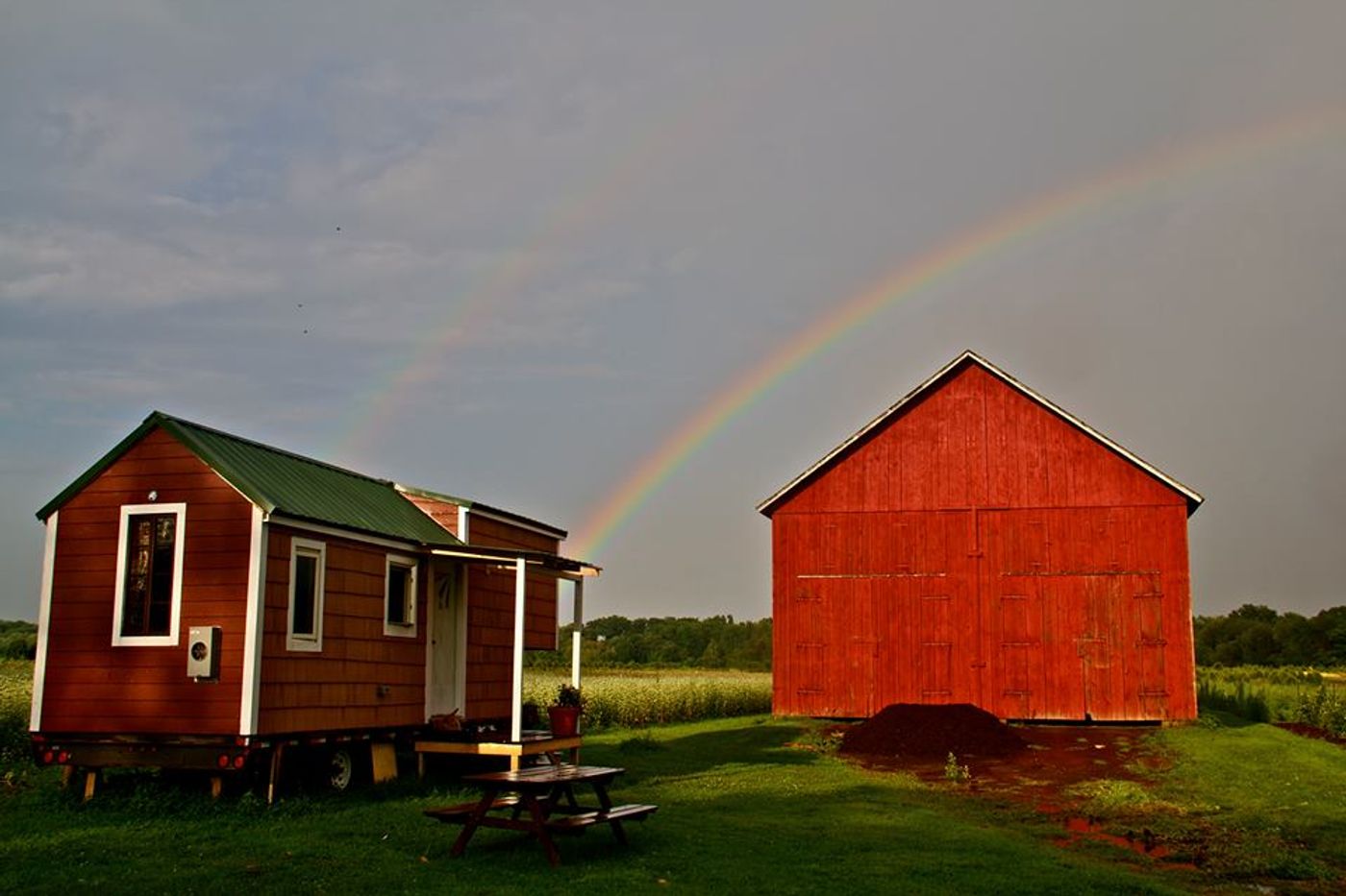 Hastings's tiny house on the left, next to the farm where she resides in Hadley, MA