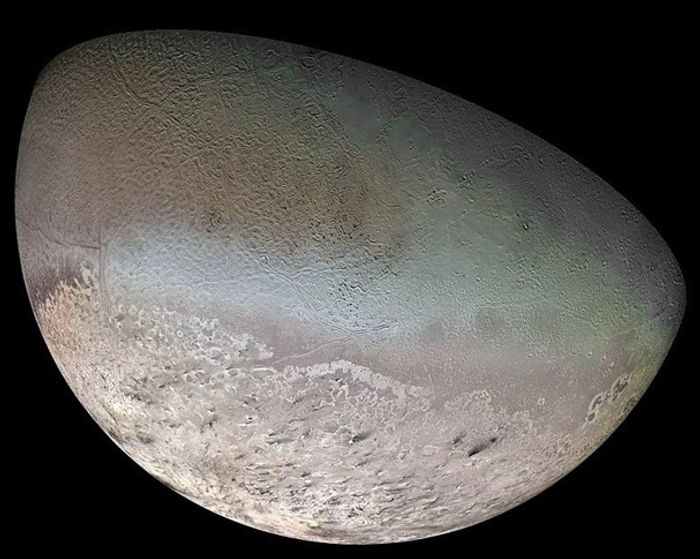 Global Color Mosaic of Triton, taken by Voyager 2 in 1989. The dark streaks are thought to be dust deposits left by nitrogen geysers. (Image Credit: NASA JPL)