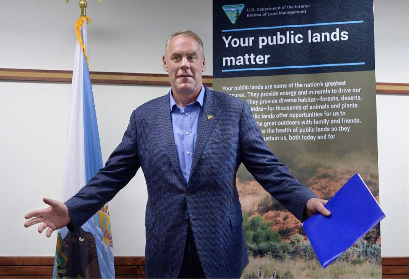 Interior Secretary Zinke, standing in front of a poster that says "Your public lands matter". Photo: Salt Lake City News Archive