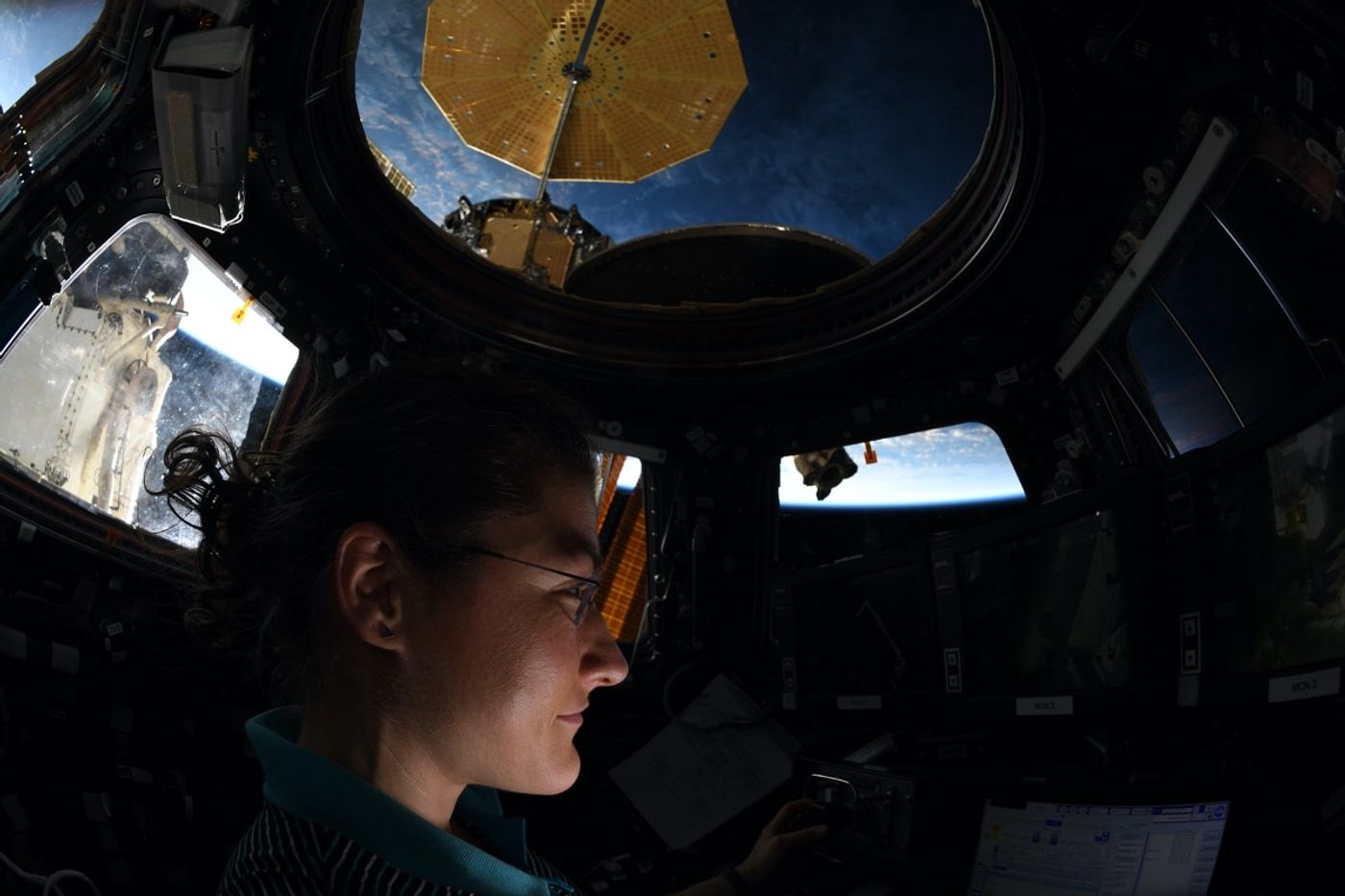 NASA astronaut Christina Koch stares out of the International Space Station's Cupola window.