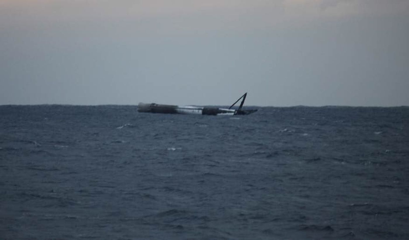 A SpaceX Falcon 9 rocket lays on its side in the Atlantic Ocean after testing a high-powered landing technique.