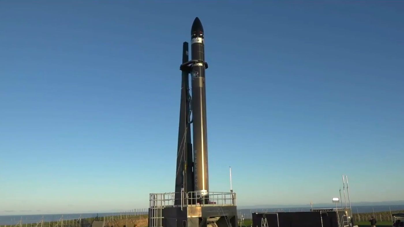 Rocket Lab's Electron rocket standing tall at the launch pad.