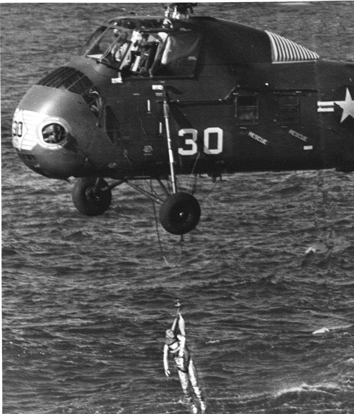 Grissom being carried to safety after his capsule sank to the bottom of the Atlantic Ocean. (Credit: NASA)