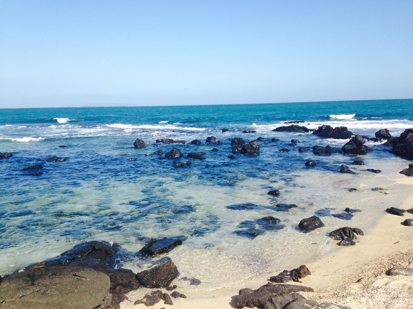 Volcanic origins give the island beaches a unique imagery. Photo: Author