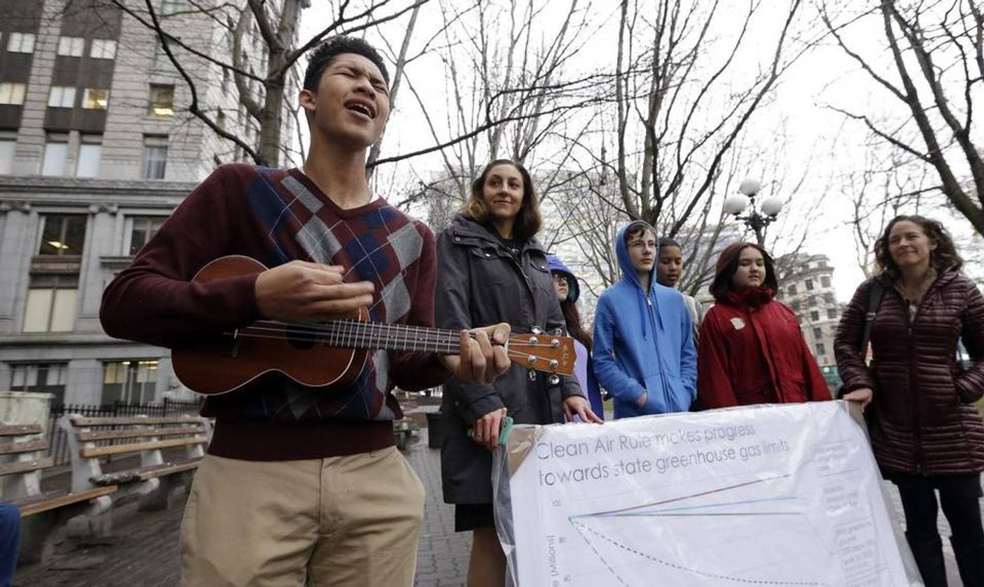 Petitioner Aji Piper, left, starts a news conference with a song as he stands with other children asking a court to force state officials to adopt new rules to limit carbon emissions, Tuesday, Nov. 22, 2016, in Seattle. Elaine Thompson AP 