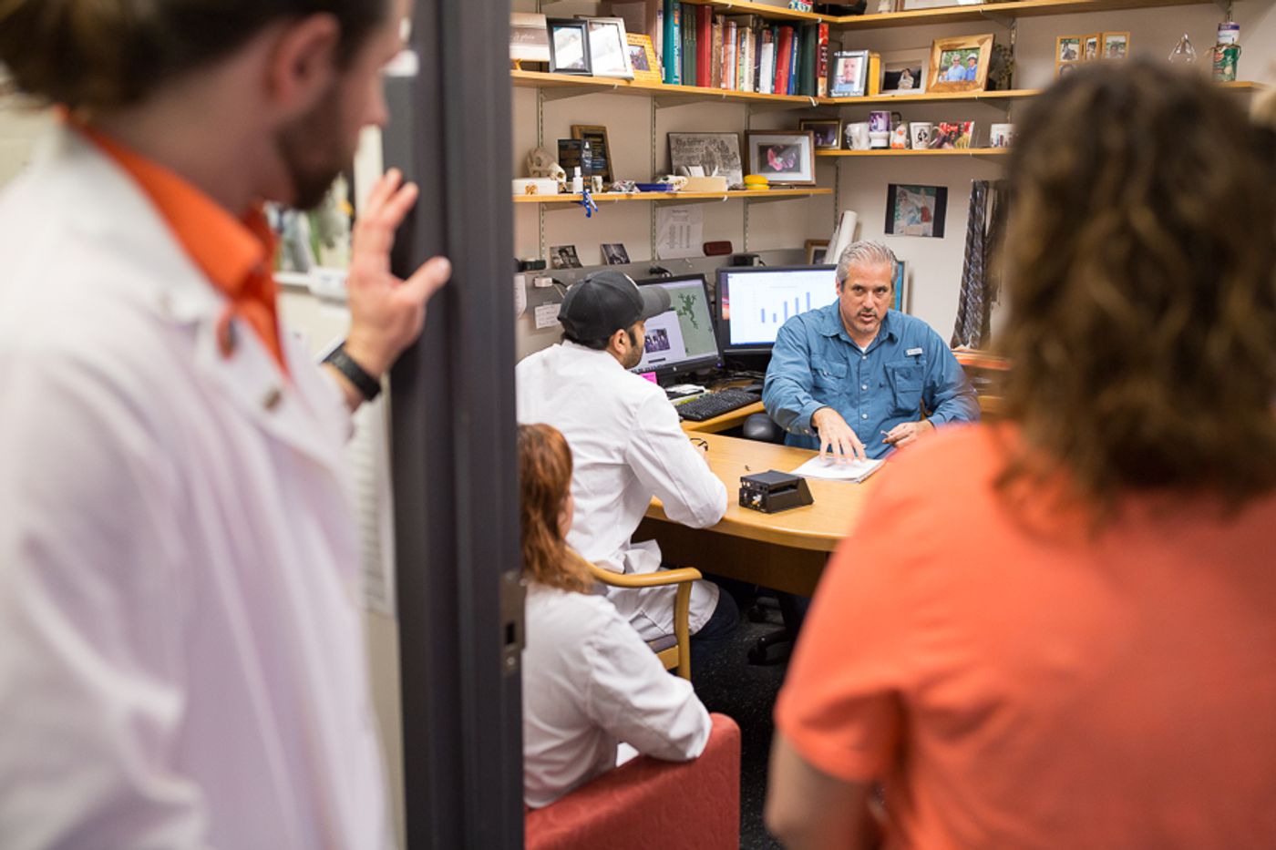 Matthew Gdovin discusses practices with his lab students. | Image credit: Scott Ball.