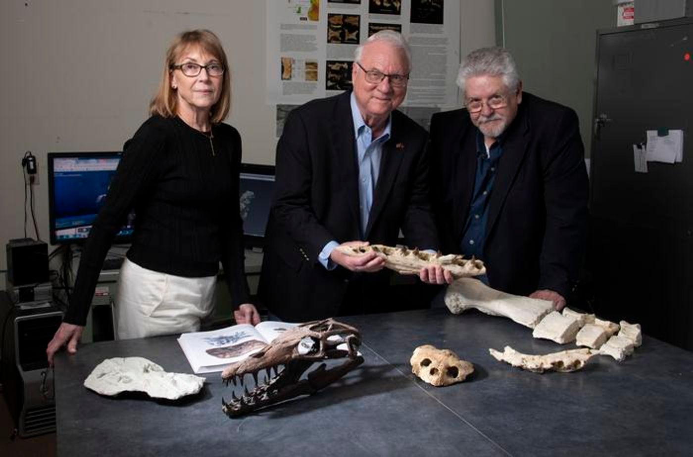 SMU paleontologists Diana P. Vineyard, Louis L. Jacobs and Michael J. Polcyn, standing with fossils found in Angola. / Credit: SMU, Hillsman S. Jackson