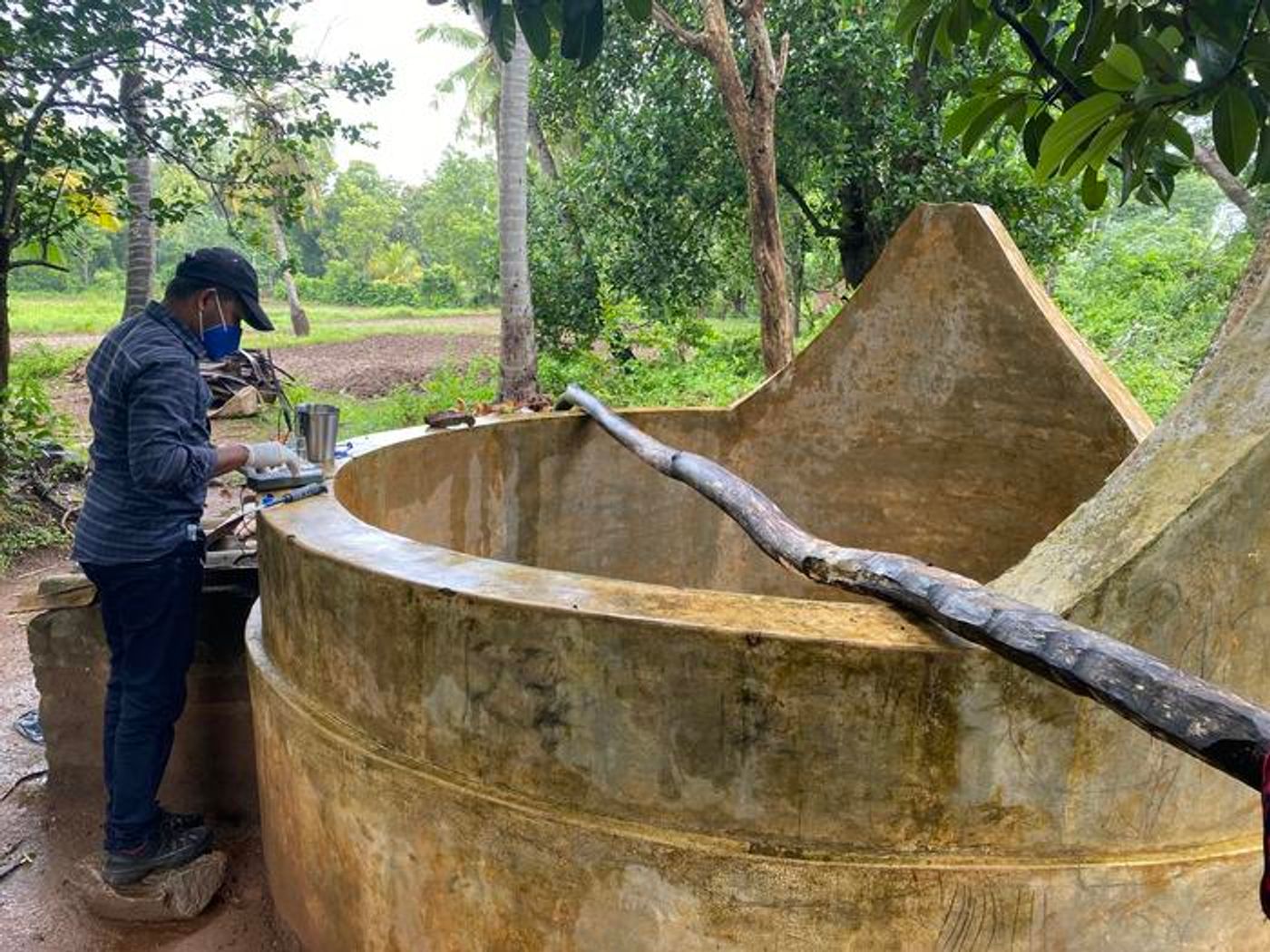 A researcher takes samples of well water in a rural community of Sri Lanka. Tests indicate that the active ingredient in Roundup may be interacting with the area's hard water to cause epidemic levels of chronic kidney disease. / Credit: Jake Ulrich, Duke University