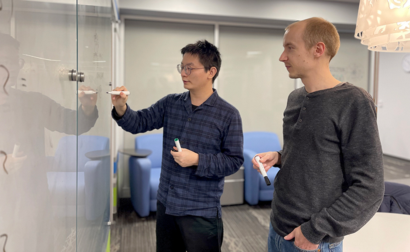 Guangjie Li (left) and Dr. Jukka Vayrynen (right) discussing calculations at the Purdue University Physics Building. (Credit: Purdue University/Cheryl Pierce)