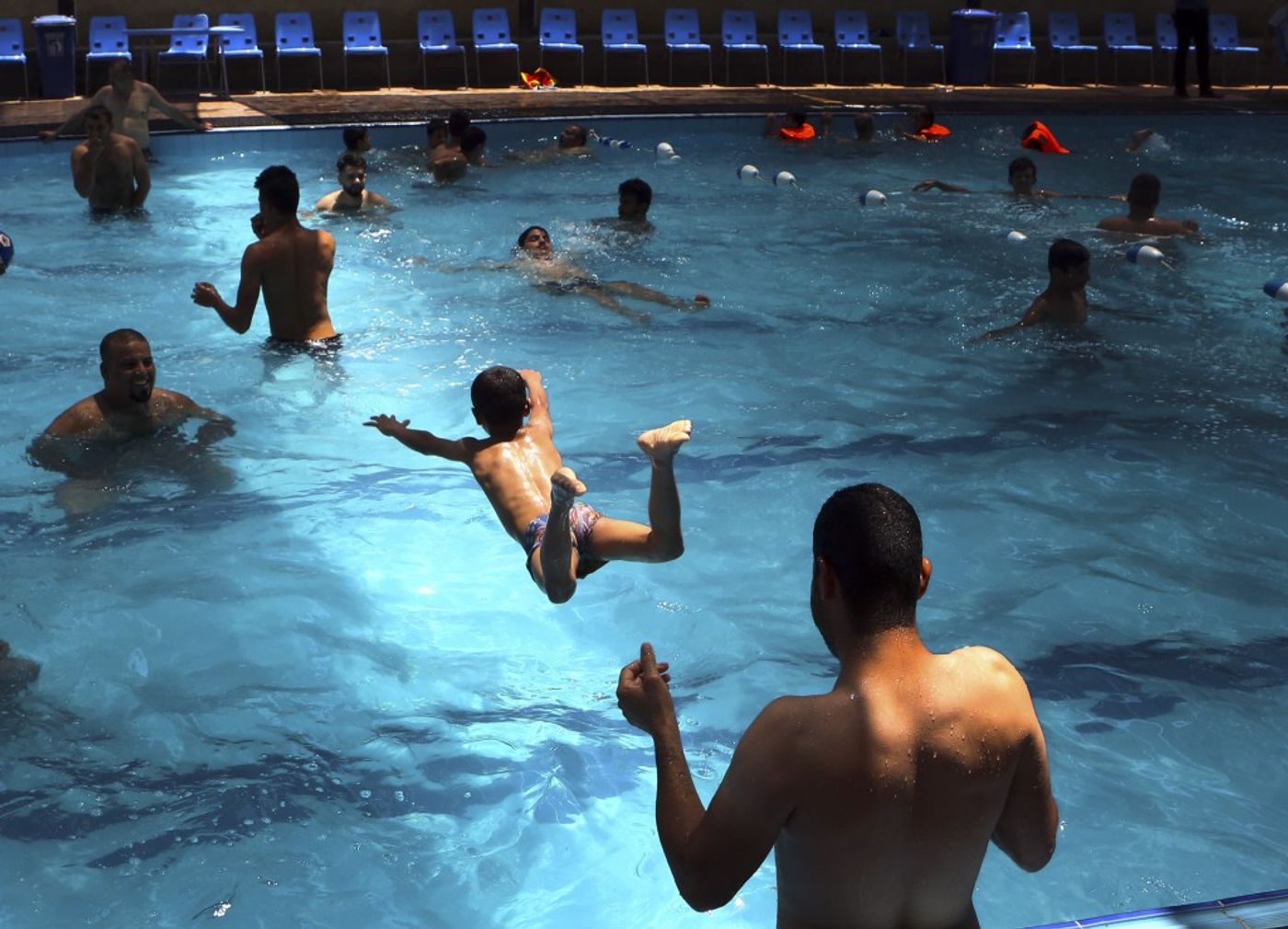 People escape the searing summer heat at a swimming pool in in Basra, Iraq, on Aug. 1. The temperature that day reached 120 degrees. (Nabil Al-Jurani/AP)