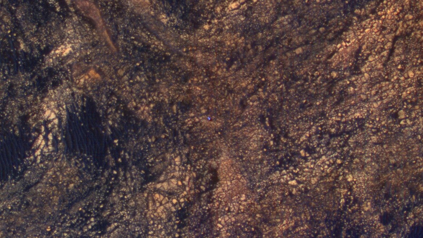 This new photograph, taken by the Mars Reconnaissance Orbiter, shows the Mars Curiosity Rover trekking the surface.