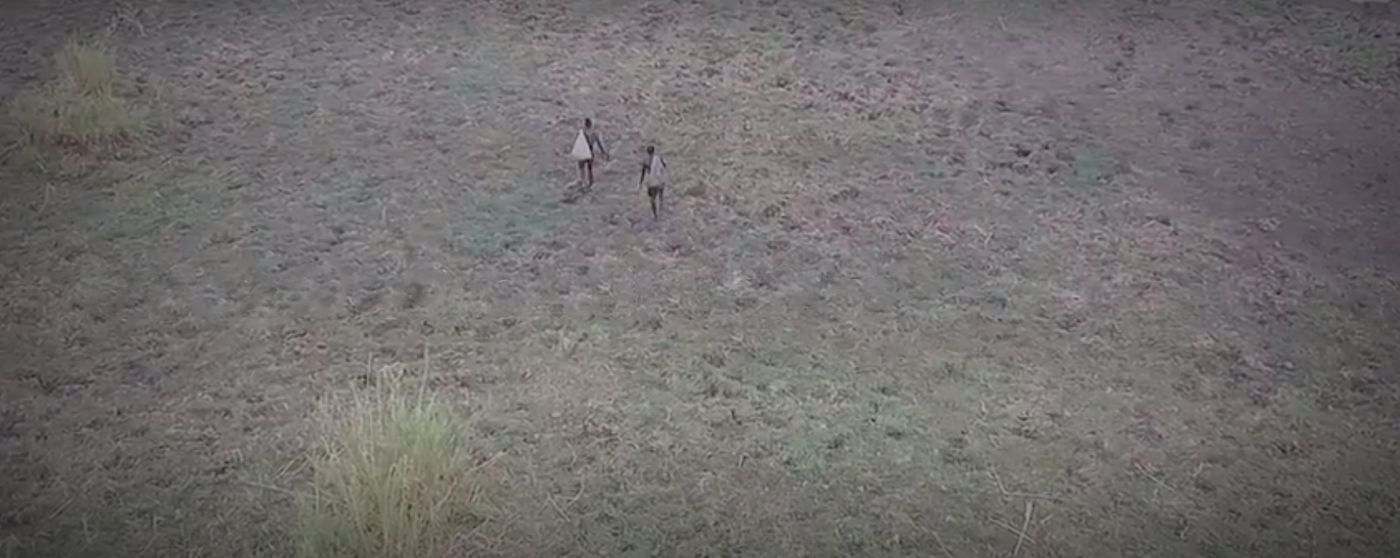 Drone footage shows poachers walking from in the skies.