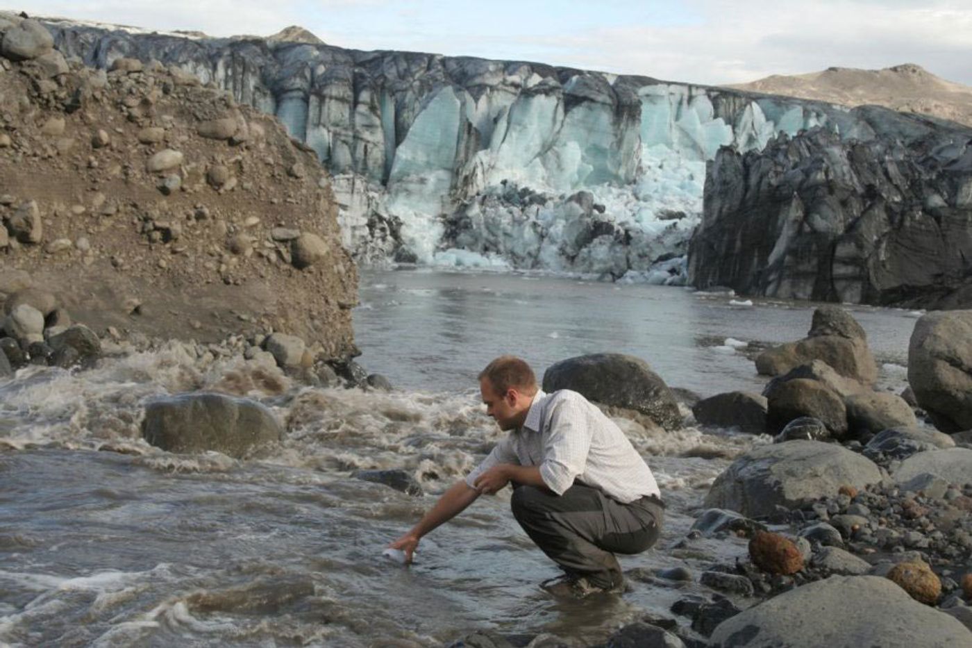 Dr. Peter Wynn collects meltwater samples. Photo: Yale E360
