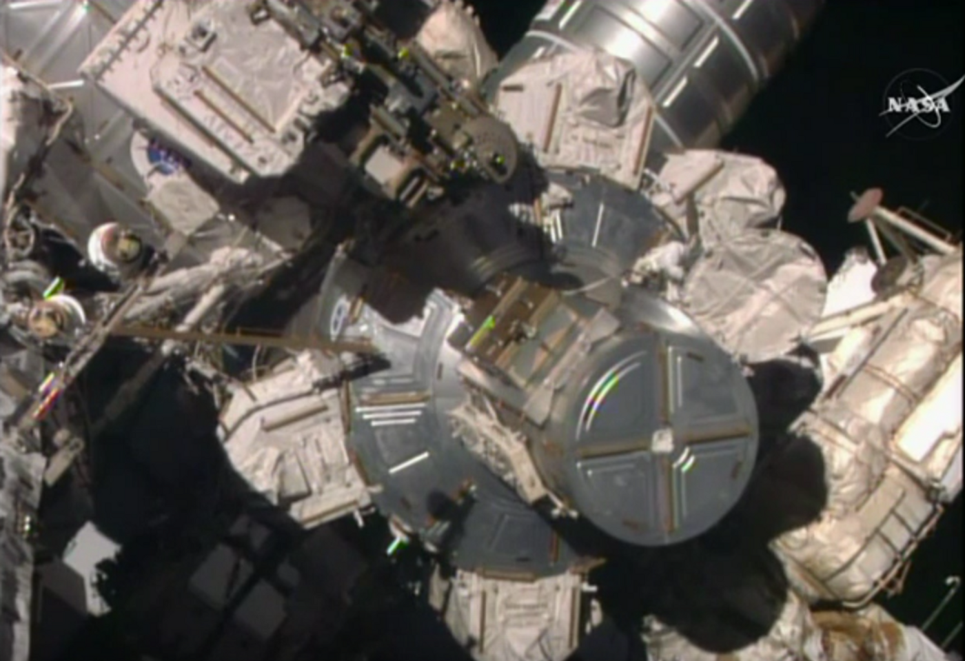 An astronaut performs repairs on the ISS Monday morning.