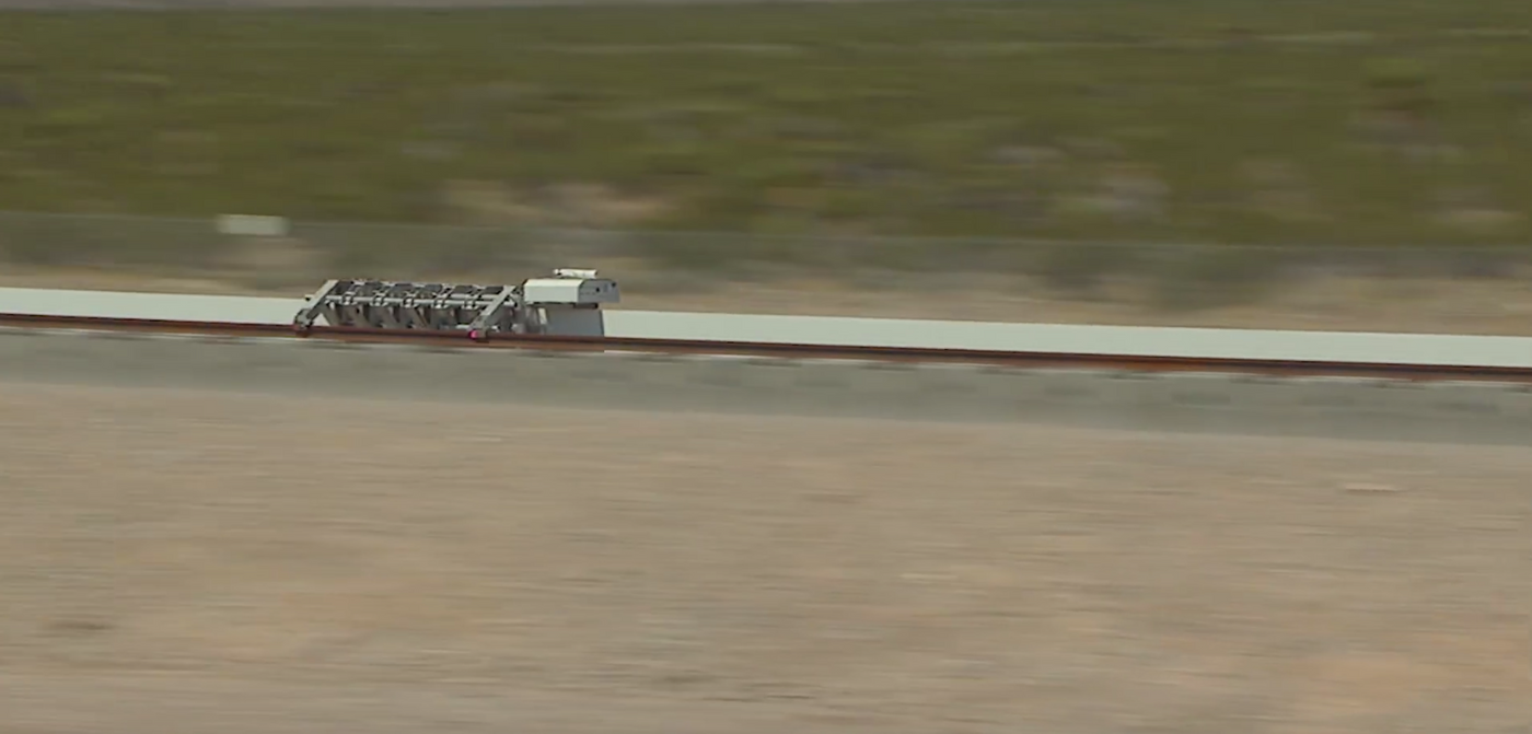 The Hyperloop One test vehicle flies down the tracks in the Nevada Desert.