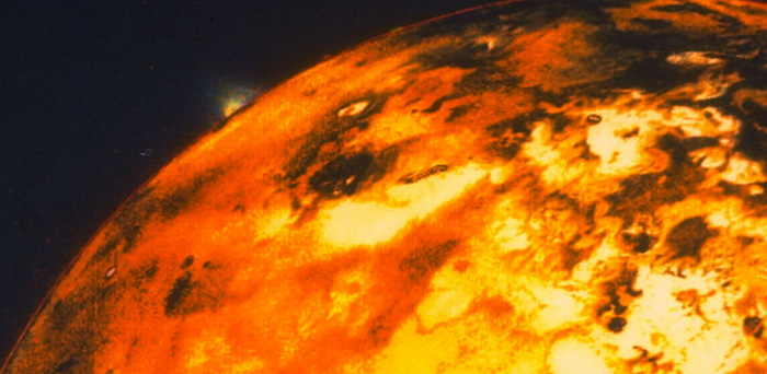 Io is a distant volcanic world that orbits Jupiter in our Solar System.