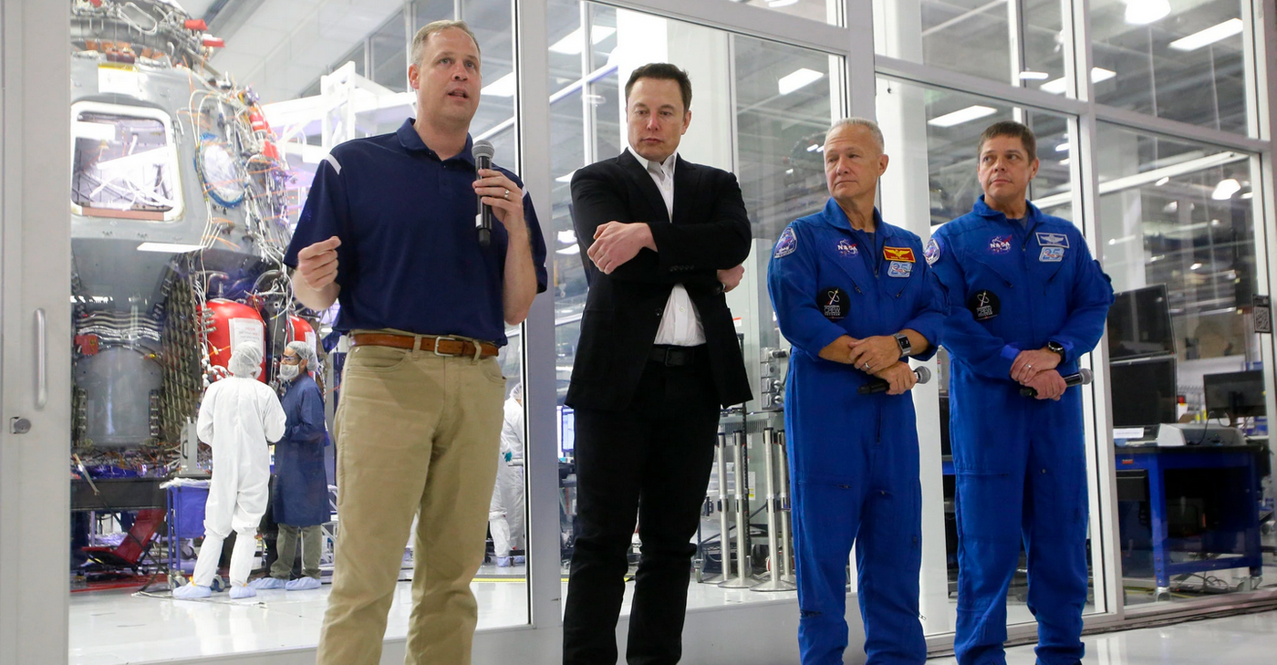 Jim Bridenstine and Elon Musk accompany two Commercial Crew astronauts during a press conference.