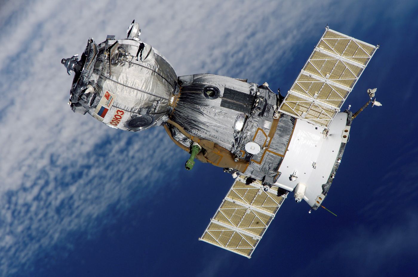 A Russian Soyuz spacecraft orbiting the Earth in space.