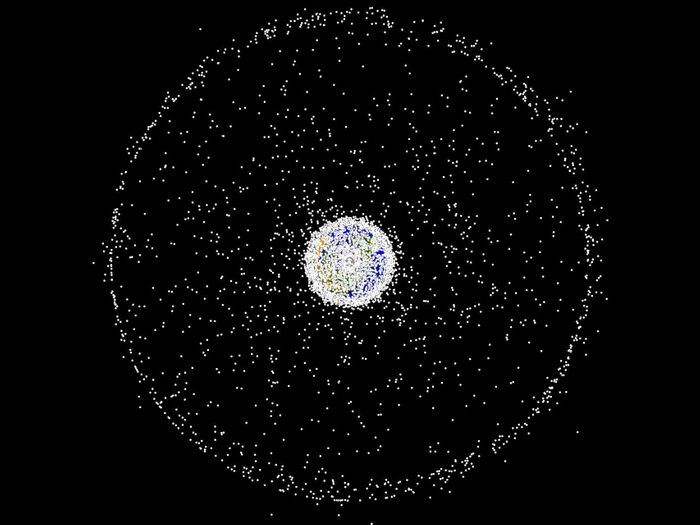 An artist's impression of the collection of space junk surrounding the Earth.