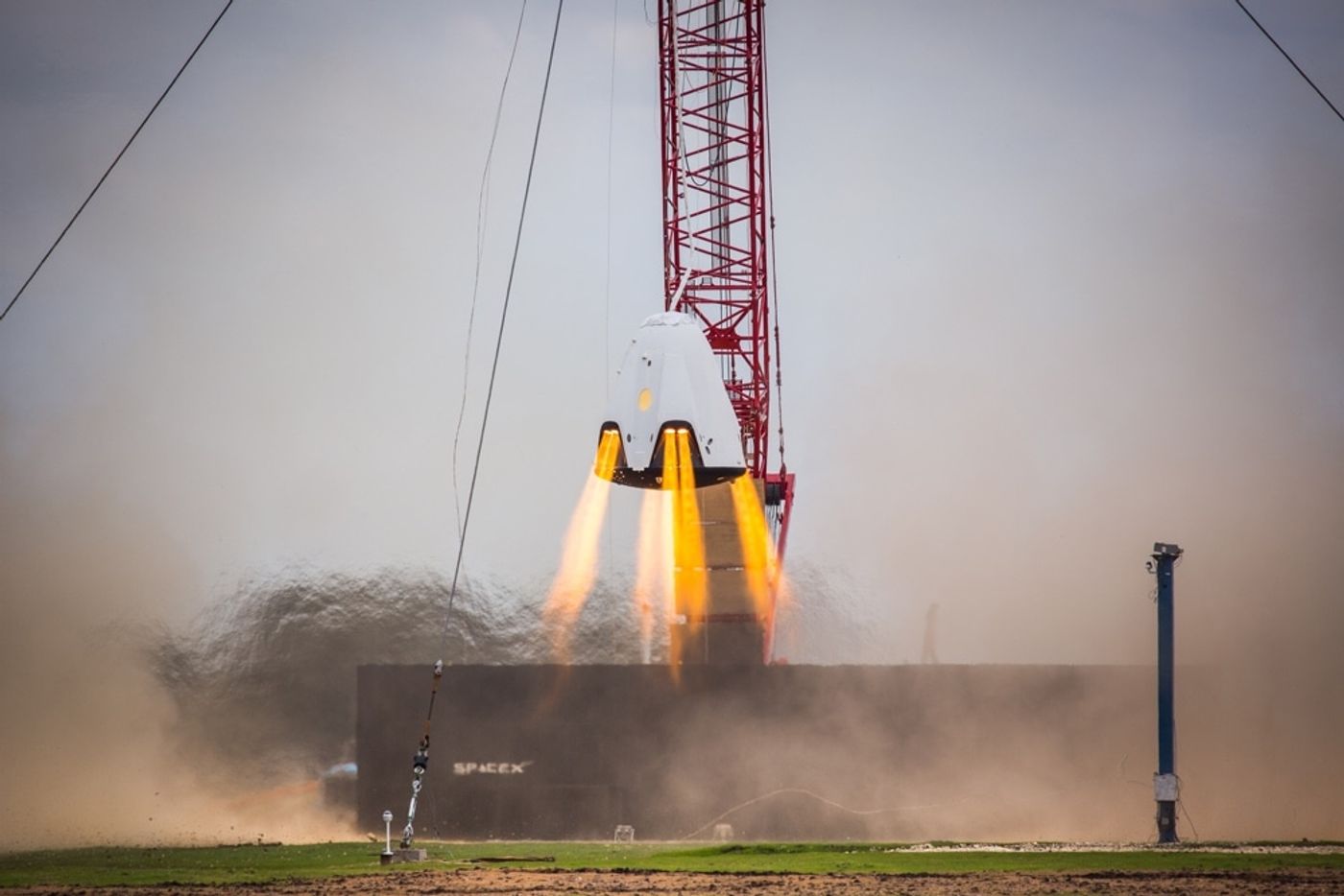 A SpaceX Dragon 2 capsule performs a hover test.