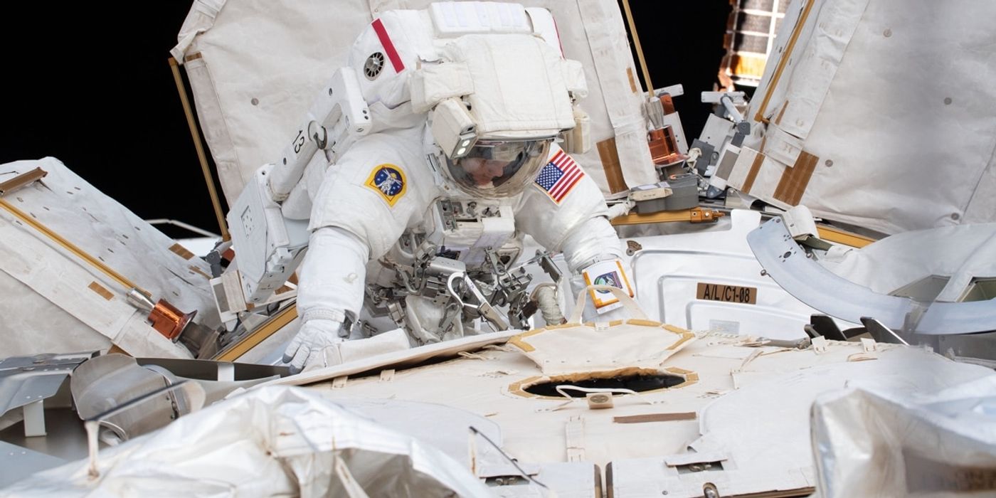 An astronaut performing a spacewalk outside of the International Space Station.