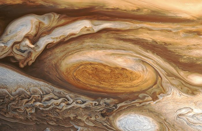 Jupiter's Great Red Spot may be the source of the planet's higher-than-expected atmospheric temperature.