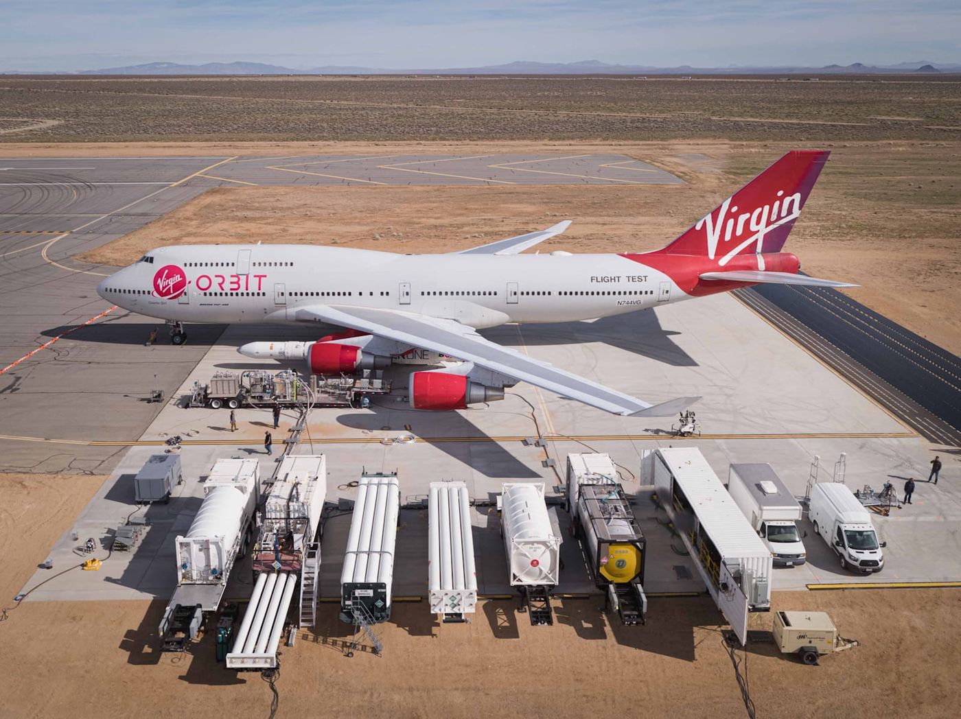 A Virgin Orbit 747 jet with its space rocket attached to the wing.